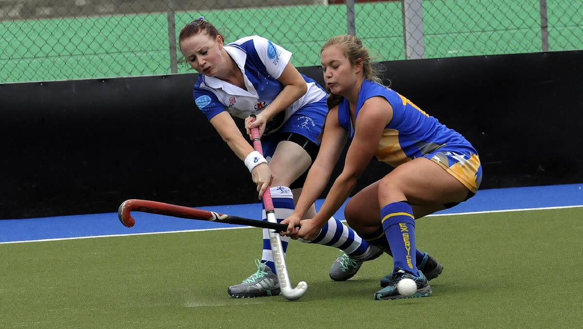 CROSS PURPOSE:  Ex-Services’ Haley Butcherine tangles with St Pats’ Kirralee Naylor during Saturday’s match at Bathurst. The match finished a 4-4 draw.
Photo: PHILLMURRAY  031514ppats 