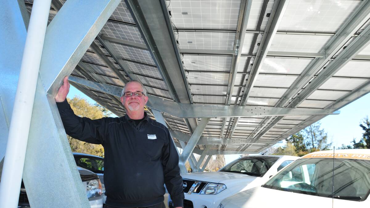 BIG SAVINGS: Wentworth Golf Club general manager Ian Starr with the solar car park installed at the club, which is the first in the central west. Photo: JUDE KEOGH 							                 0815wentysolar4
