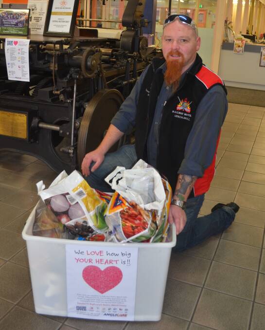 GENEROUS OFFERINGS: Anglicare’s Garrett Baird collects the first load of food donations left at the Central Western Daily last week. Photo: JANICE HARRIS                                                                               anglicare3
