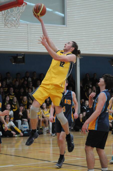 JUMP START: Orange High’s Max Pearce gets his shot up during the basketball win over Bathurst High in Astley Cup action yesterday. Photo: STEVE GOSCH 0620sgastley1