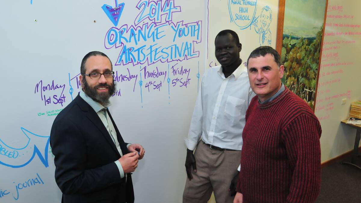 TOGETHER FOR HUMANITY: Rabbi Zalman Kastel, Alfred Ngong from South Sudan and Vince Lovechio from Canobolas Rural Technology High School plan for the Youth Art Festival. Photo: JUDE KEOGH 0715rabbi
