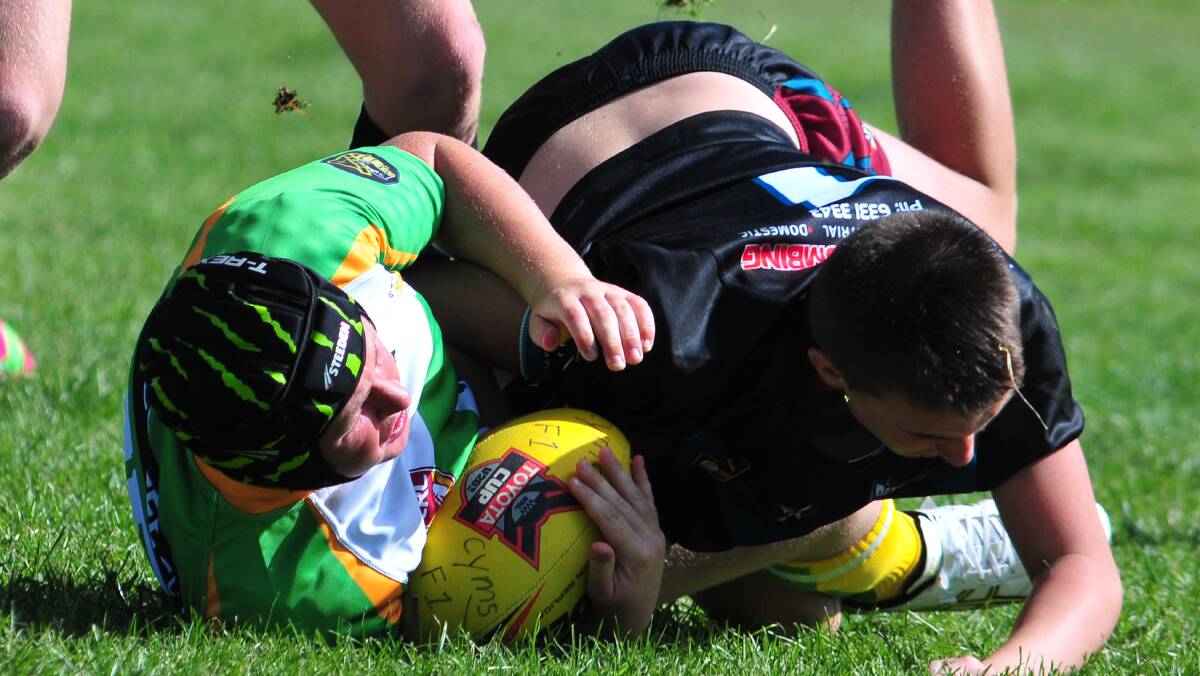 RUGBY LEAGUE: CYMS' James Dalton is tackled by an under 15s Bathurst Panthers opponent. Photo: STEVE GOSCH
