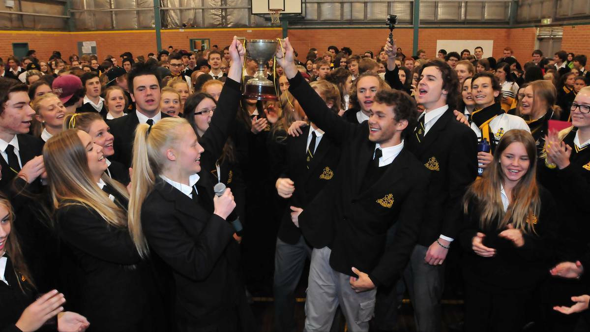 WE ARE THE CHAMPIONS: School captains Meaghan Kempson and Trent French (with cup) lead Orange High in its Astley Cup win celebrations. Photo: JUDE KEOGH 0627astley7