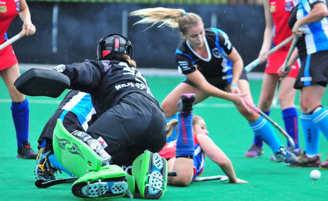 HOCKEY: Goalkeeper Kim Northey in the thick of the play during Saturday's Premier League Hockey game between Confederates and Lithgow Zig Zag. Photo: JUDE KEOGH