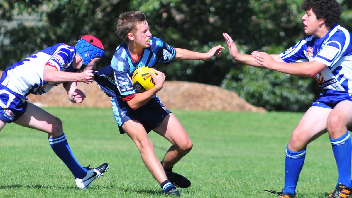 RUGBY LEAGUE: Bloomfield's Will Christopherson fends off his Bathurst St Pat's opponents on Saturday. Photo: STEVE GOSCH