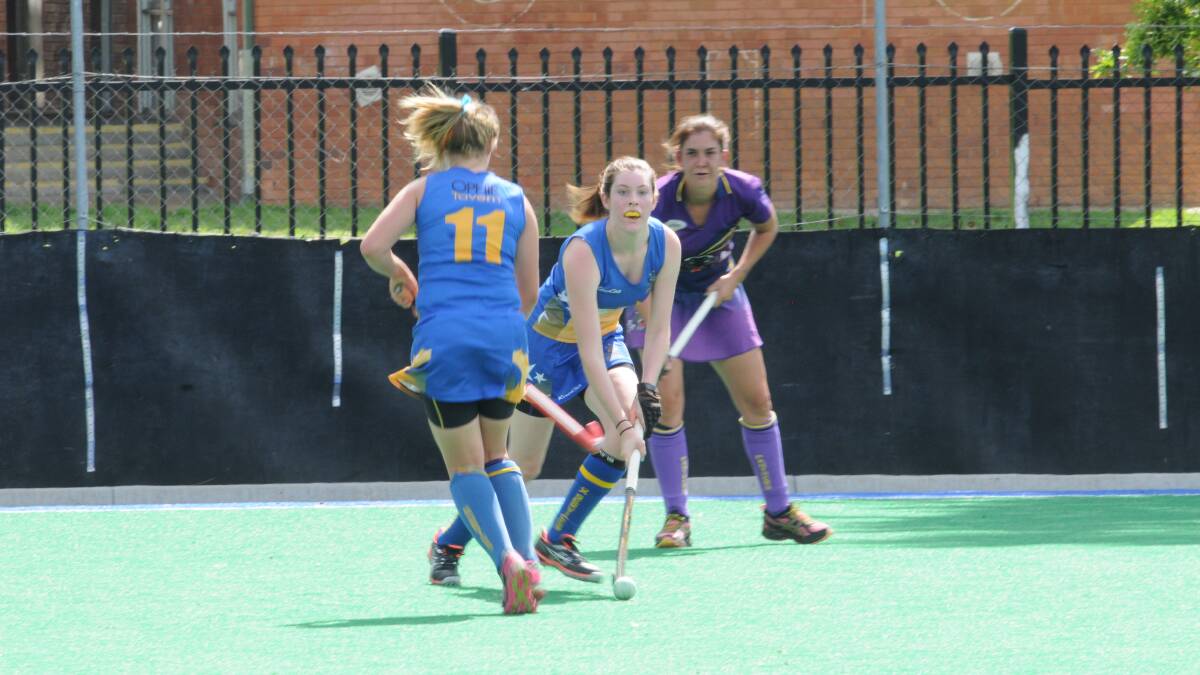 HOCKEY: Ex-Services' Rachel Pengilly and Tiffany Atkinson fend off Lithgow Panthers' Roxanne van Veen. Photo: LUKE SCHUYLER