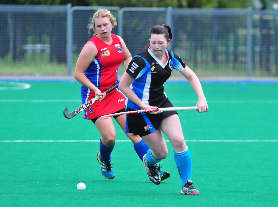 HOCKEY: Georgia Parr and Sam Hill fight for the ball in Saturday's Premier League Hockey game between Confederates and Lithgow Zig Zag. Photo: JUDE KEOGH