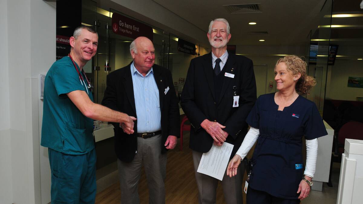 GREAT PERFORMANCE: Head of Orange hospital’s accident and emergency department, Dr Colin Dibble, is congratulated by Orange Health Council chair Phil Baker, and vice-chair Richard Jane at yesterday’s announcement with nursing unit manager Meg O’Brien.
Photo: JUDE KEOGH 0715ed1
