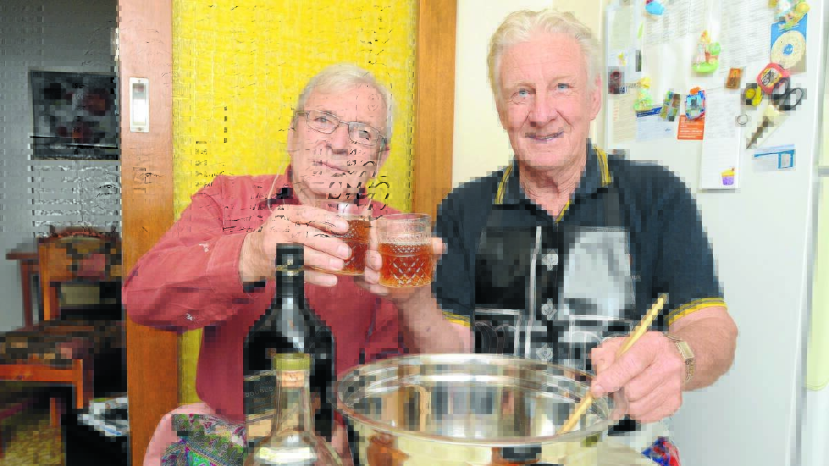 CHEERS TO ROBBIE: Orange and District Scottish Association and Burns Club members David Howell and Ken Harper mix the atholl brose for February’s Burns Supper. Photo: JUDE KEOGH                                                                                                                                                                              1216burns1
