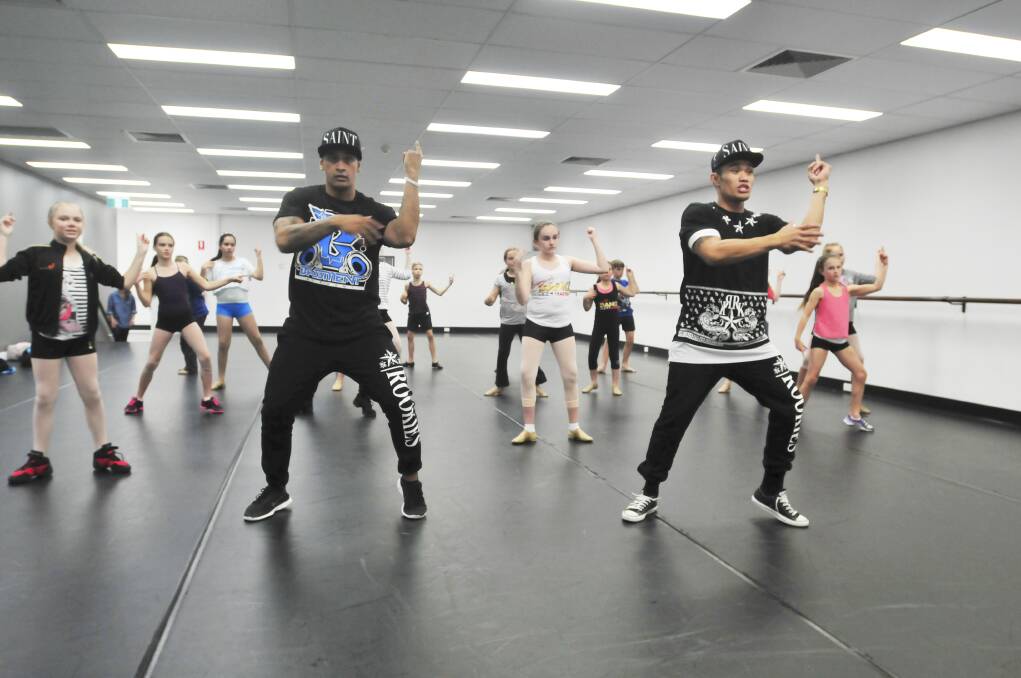 NEW CREW: Wyllis Maihi and Emmanuel Rodriguez take young dancers through their paces. Photo: JUDE KEOGH                                      0525dance1