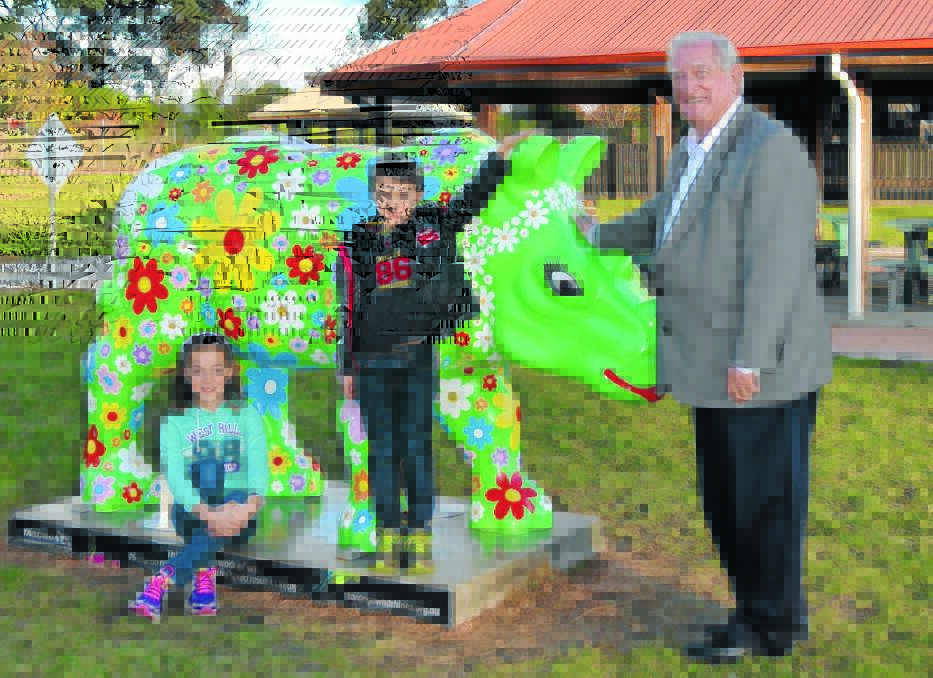 AND THE WINNER IS: Ethan Dawson (centre) with his sister Cally and Orange  mayor John Davis check out the life-sized rhino at the Adventure Playground that  now bears the name Rosie. Photo: JANICE HARRIS 
