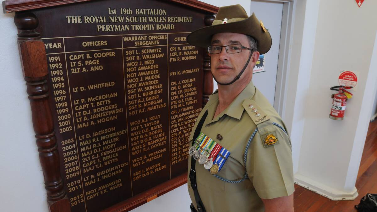 ROLE TO PLAY: Captain Frank Ware with the Peryman Trophy Board at the Orange army barracks. Photo: STEVE GOSCH                  0424sganzac1