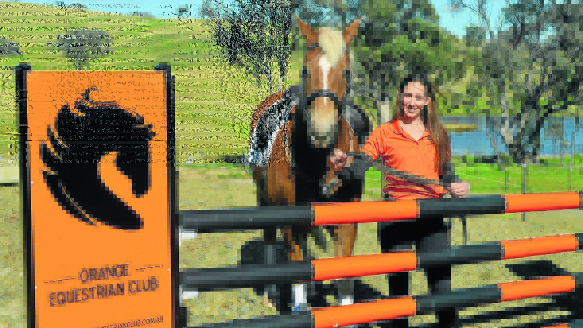 TAKING THE REINS: Orange Equestrian Club publicity officer Jess Jonkmans, with Spyda, shows off one of the new  jumps on show on Sunday. Photo: MATT FINDLAY                                                                                                                                                                                                   0821mfshowjumping
