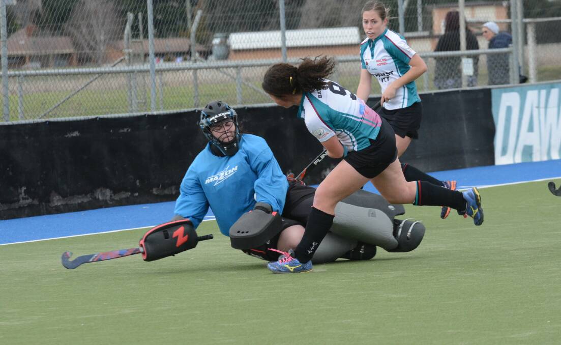 NOT THIS TIME: Bathurst City's Danielle Fisher has her shot blocked by Confederates goalkeeper Steph Hinds but City would still get plenty past her in their 7-1 win on Saturday. Photo: PHILL MURRAY 071214pcity11