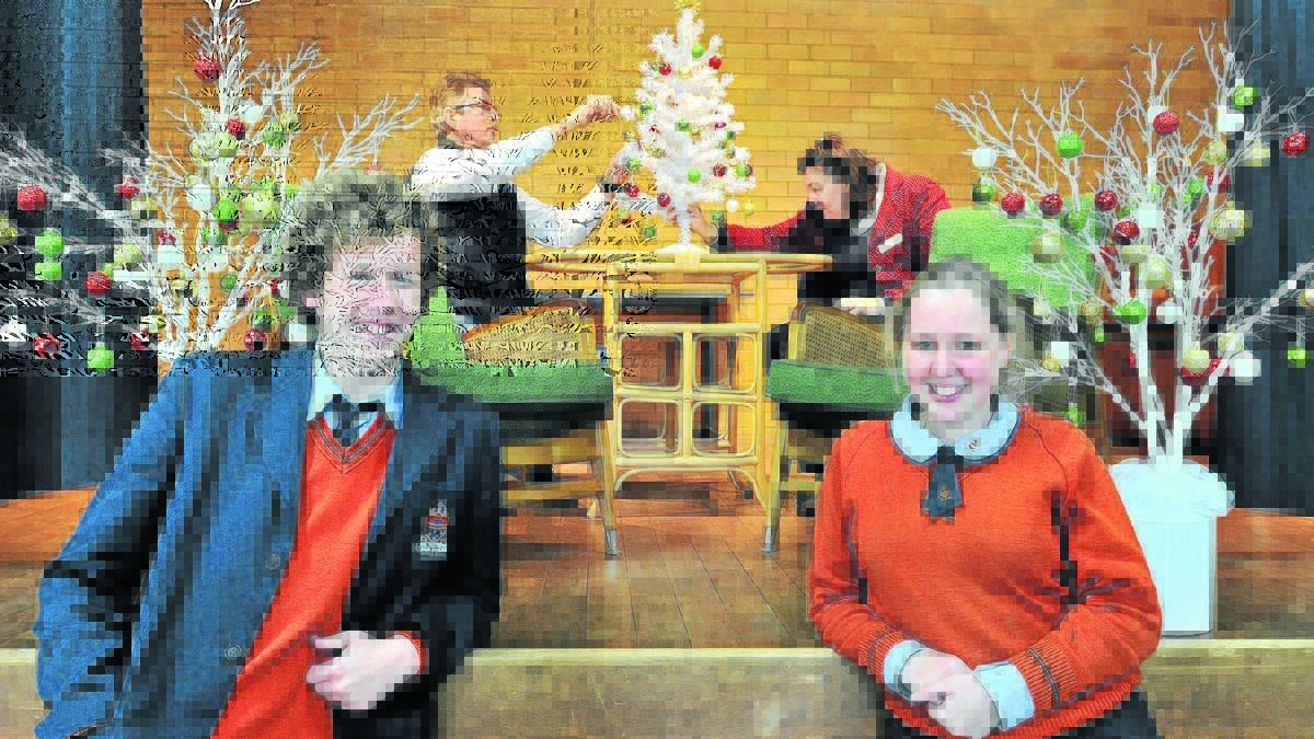 YULETIDE TREAT FOR YSABEL: Outreach project committee members (back) Rod Wykes and Trish Balcomb and Orange Anglican Grammar students Joshua Dunnett and Georgia Balcomb prepare for this weekend’s Christmas in July fundraiser. Photo: STEVE GOSCH    0715sganglican1