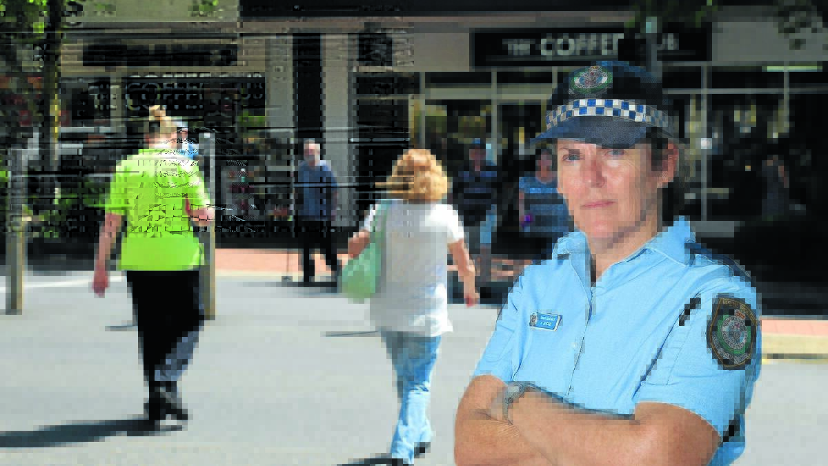 POLICE STING: Senior Constable Alison Hodge at the post office pedestrian lights. Police issued eight on-the-spot fines to pedestrians in Summer Street during a blitz in Orange yesterday. Photo: PHIL BLATCH
