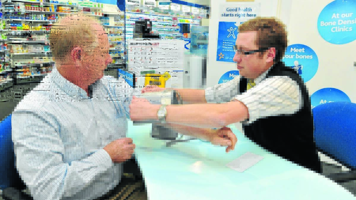 PRESSURE’S ON: Pharmacist Tim Gray says the personalised monitoring of customers such as Bill Marriott cannot be replicated if health checks in supermarkets such as Woolworths are introduced in Australia. Photo:JUDE KEOGH 0702woolies1
