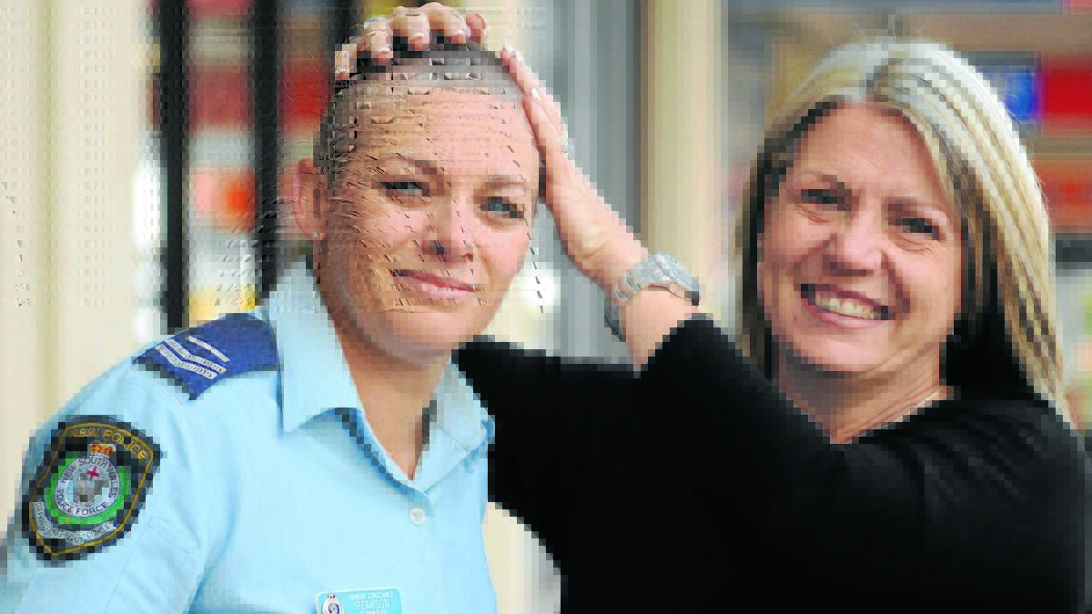 COP IT SWEET: Senior Constable Lisa Pearson shaved all her hair off to raise vital funds for Francine Sammut on Saturday. Photos: STEVE GOSCH                                                                                               0712sgshave1
