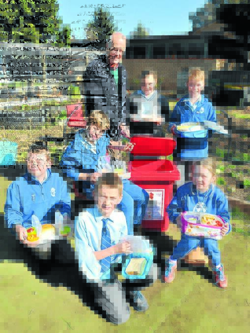 REDUCE, REUSE, RECYCLE (left): Councillor Neil Jones, Calare Public School students Alexis Eldridge-Smith and James Chrisp  (back), Jasper Leahy, Xaxon Liegh and Sam Armstrong and Ilah Ody (front) showing off their nude food meals for the day. 
Photo: JUDE KEOGH  
