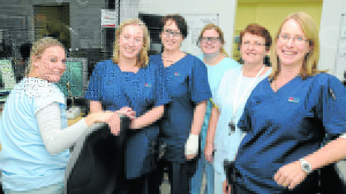 ENGINE ROOM AT THE LAB: Orange’s award-winning heart nurses Lozzie Vardenaga, Maryanne Burgess, Meagan Johnson, Allison Hembrow, Maudy Lawrance and acting nurse unit manager Kath McMaster in the cardio catheter laboratory at Orange hospital where patients undergoing heart stenting are monitored. Photo: STEVE GOSCH 0508cath