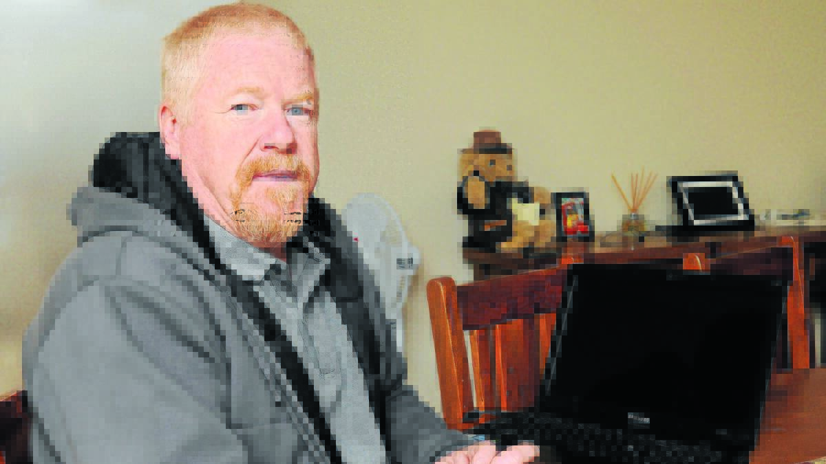 CLOSE BUT NO SERVICE: Winter Street resident Chris Fauchon is frustrated he cannot access ADSL broadband at his house despite houses across the road being connected to the internet service.
Photo: STEVE GOSCH  