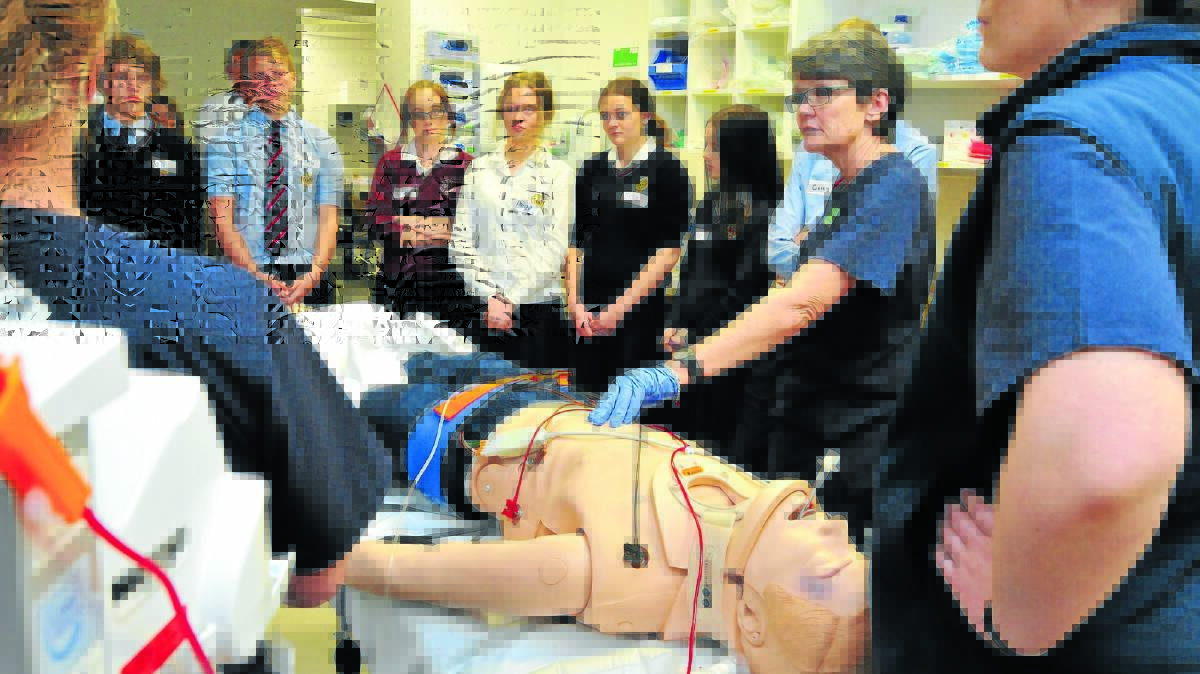 TELLING IT LIKE IT IS: Students Sam McKinley, Lachlan Lingley, Tahlia Brown, Paige Wallace, Jess Beasley and Jess Bishenden watch Orange hospital trauma clinical nurse consultant Vicky Conyers use the scenario of a young student with life threatening spinal injuries as part of an education program to help young people avoid risk taking behaviour. Photo: JUDE KEOGH 0808hospital21