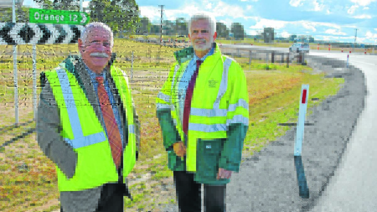 OPEN FOR TRAFFIC: Orange City Council Airport Advisory Committee chair councillor Chris Gryllis and operations manager John Boyd are pleased to see the first cars use the newly re-opened airport road.  Photo: CONTRIBUTED