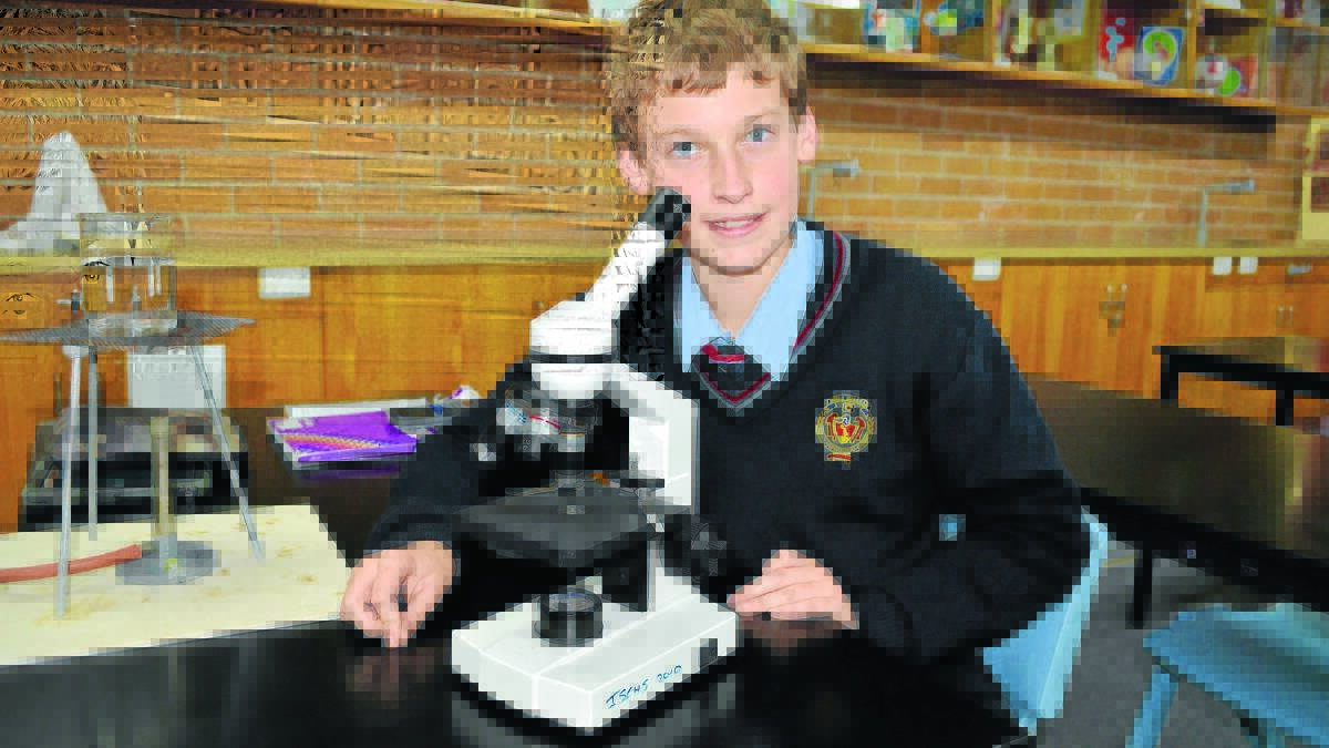 UNDER THE MICROSCOPE: Jack Lynch-Maclean, 14, enjoys learning about science and by the time he reaches year 12 it could be compulsory learning if a concept raised by federal Education Minister Christopher Pyne takes off. Photo: TANYA MARSCHKE         
