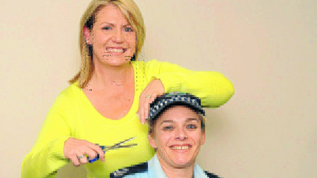 THE FORCE IS WITH FRANCINE: In a trial run young mother Francine Sammut snips the hair of her good friend Senior Constable Lisa Pearson who has organised Shave to Save to help pay for lifesaving chemotherapy for her former police colleague. Photo: STEVE GOSCH
