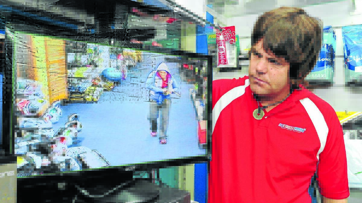 IN OUR SIGHTS: SportsPower worker Adam Hurford uses “cameras everywhere” to deter people from shoplifting from the store. 
Photo: JUDE KEOGH 
