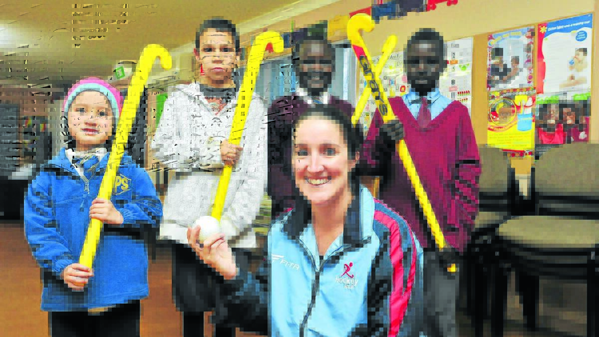 EXCITED: Siam Elkington, Max Boney, Aweil Malual, Kon Yai and Hockey NSW’s Kate Pulbrook (front) are looking forward to the next after school hockey program run as part of the SKILL for Community Harmony in Orange event. Photo: JUDE KEOGH 														          0624bowenhockey2