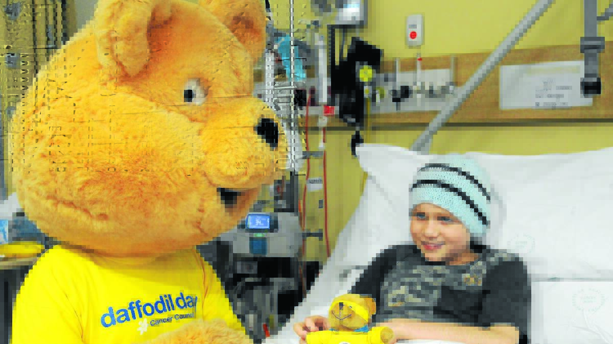 SPECIAL VISIT: Orange hospital children’s ward patient Will Coady-Jiear with Cancer Council’s mascot Dougal Bear.
Photo: STEVE GOSCH 0821sgdaffodil1
