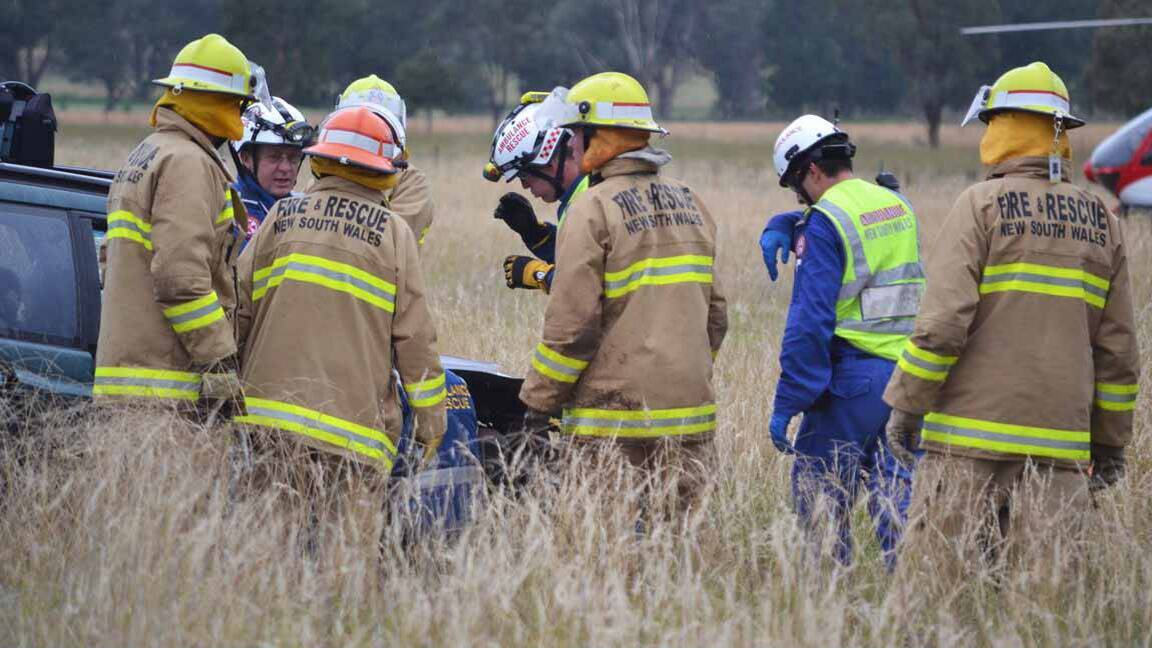 TO THE RESCUE: Emergency services crews work to free one of the victims of yesterday’s collision  near Canowindra.                                                       Photo COWRA GUARDIAN