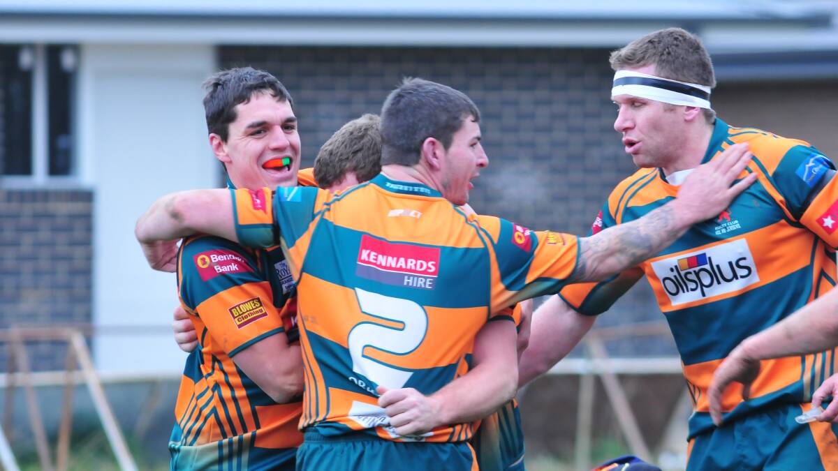 HAPPY CAMPERS: Orange City's (from left) Sam Powell, Chris Senior and Josh Maley celebrate a Lions try in last weekend's tough win over Forbes. Photo: JUDE KEOGH 0705city3