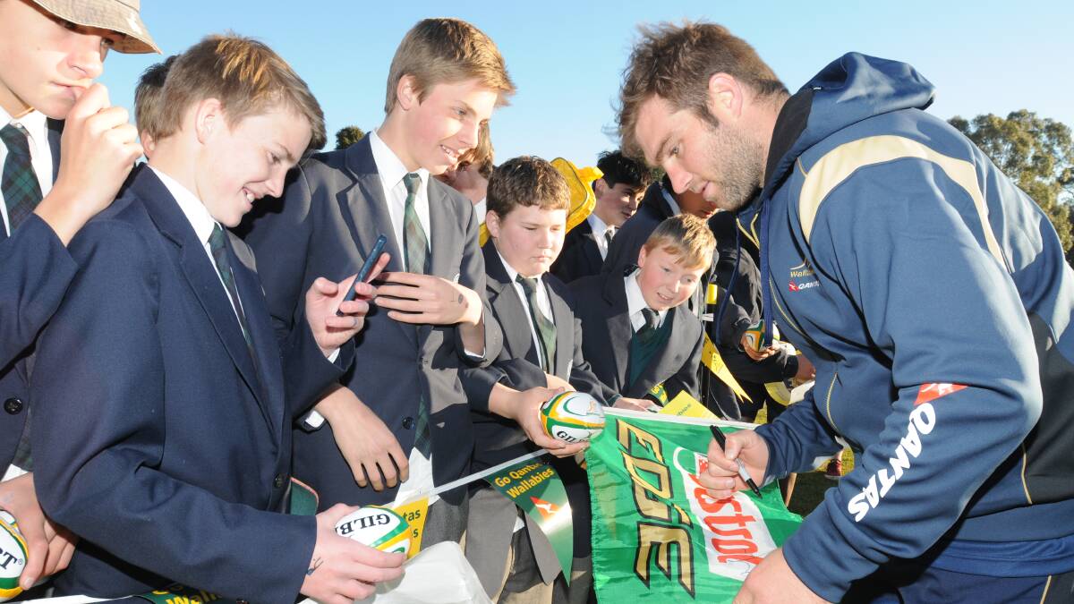 THE BIG DOG’S HOME: Wallabies’ No.8 and former Kinross student Ben McCalman returned to his old school yesterday as part of the Bush2Bledisloe campaign yesterday, with adoring fans on hand to snare a photo or autograph. 										        Photo: STEVE GOSCH 0805sgwal26
