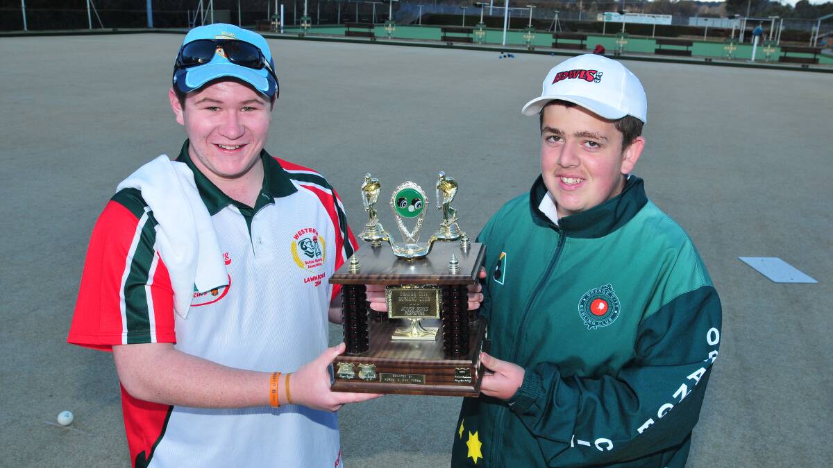 TROPHY HAUL: Brad Roberts (left) and Nathaniel Carr will be trying to take home the Orange City Junior Tournament trophy this year. Photo: JUDE KEOGH 0813jrbowls3