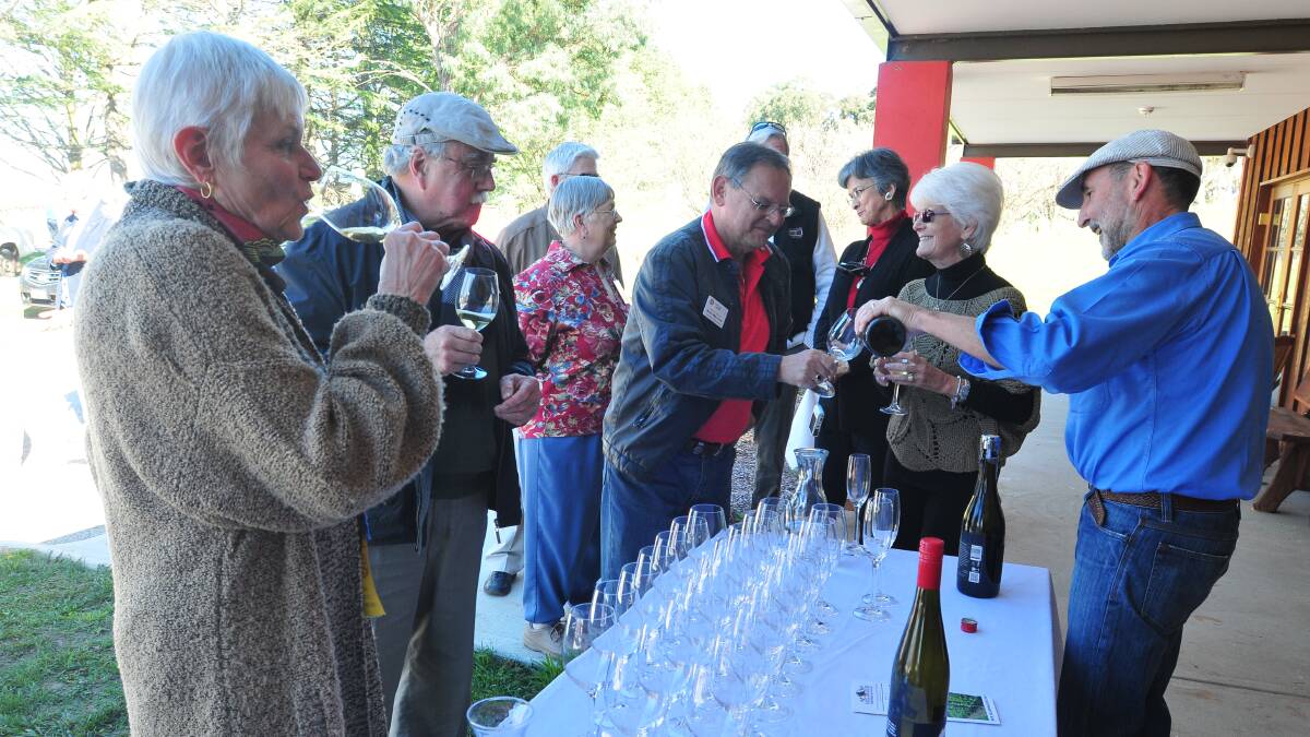 TOP DROP: Nan and David Greenwood, Bruce Mills and Cheryl Minshew enjoy a glass of wine with some guidance from Charles Sturt University’s Justin Byrne. Photo: JUDE KEOGH 0607wine9