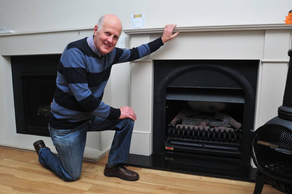 HOT TOPIC: Councillor Neil Jones shows off the range of environmentally friendlier heater optons available as part of the 'Stay Warm, Breathe Easy' campaign yesterday. Photo: JUDE KEOGH 0520woodheat3