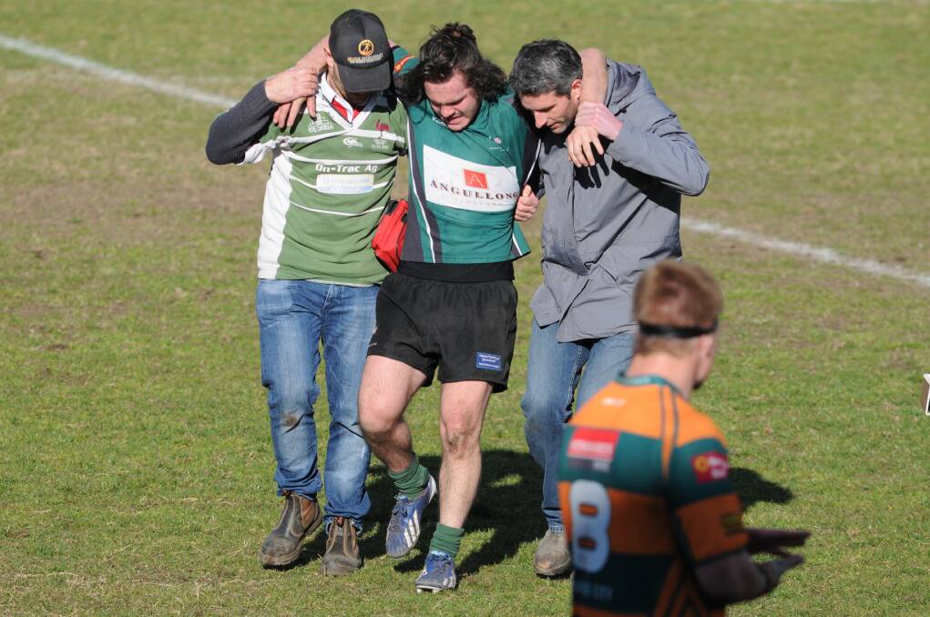 PERRI OUT? Adam Perri is helped off the field in last Saturday's loss to City. 
Photo: STEVE GOSCH 0823sgrugby7