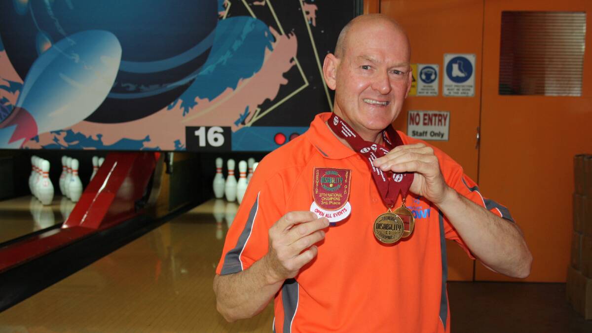 DOUBLE UP: David Hayward shows off his two bronze medals won at the National Disabilities Tenpin Bowling Championships. Photo: MICHELLE COOK 0622mcdavid