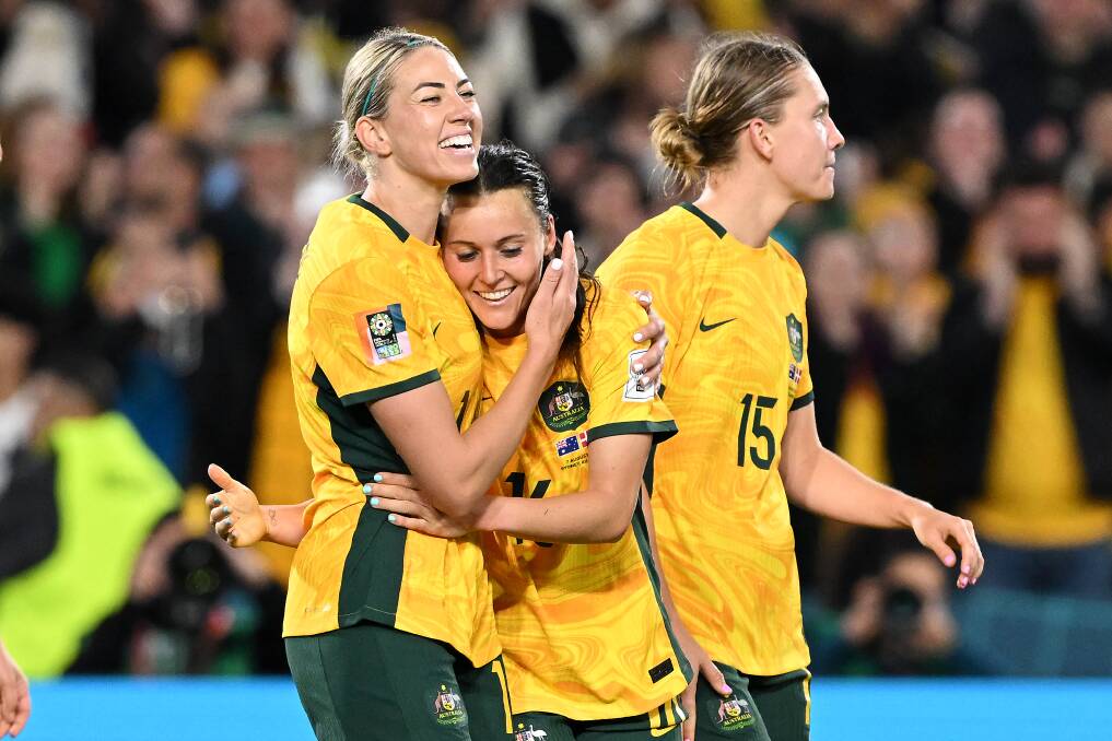 Hayley Raso of Australia celebrates with teammate Alanna Kennedy after scoring a goal during the match between Australia and Denmark on Monday, August 7, 2023. (AAP Image/Dean Lewins)
