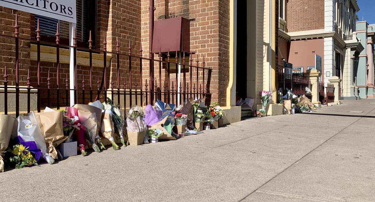SUPPORT: A row of flowers laid outside a building in Mudgee's CBD.