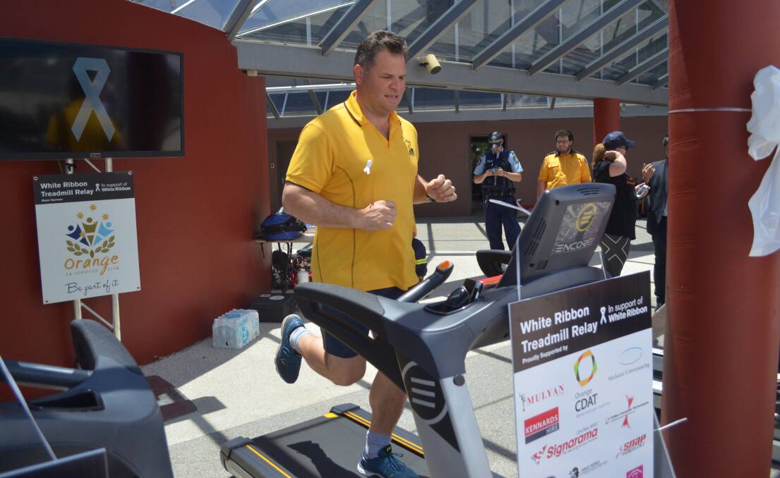 Member for Orange Phil Donato puts his best foot forward to the support Orange's White Ribbon Day 24-hour treadmill relay on Friday. Photo: DECLAN RURENGA