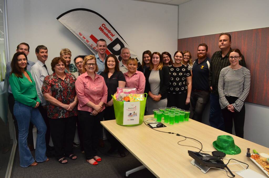WORTHY CAUSE: CWD staff hand over donations to Housing Plus.