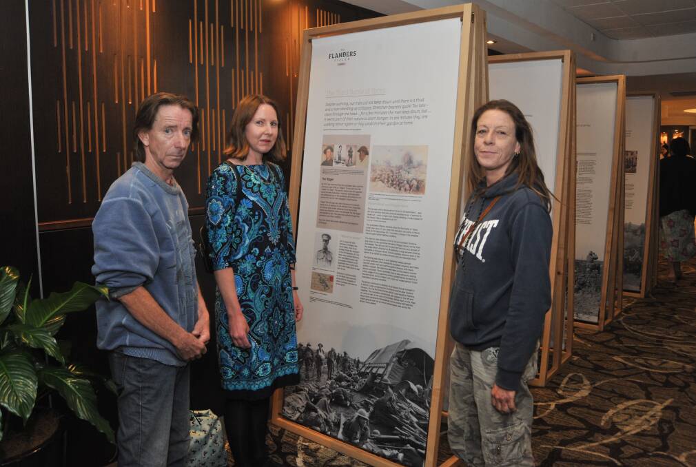 COMMEMORATION: Steve Power, Leigh Hunter, Christina Ambrose look through the exhibition at Orange Ex-Services' Club. Photo: JUDE KEOGH 1107jkexserv1