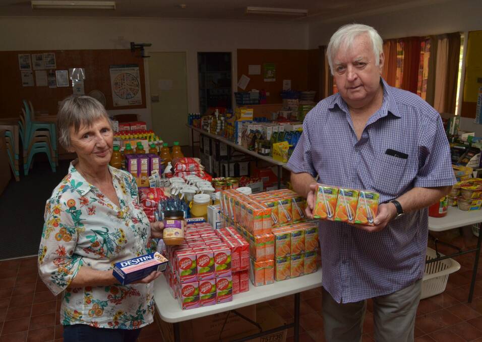 STOCK SAVED: FoodCare's Anne Hopwood and Councillor Ron Gander with stock saved from the fire.