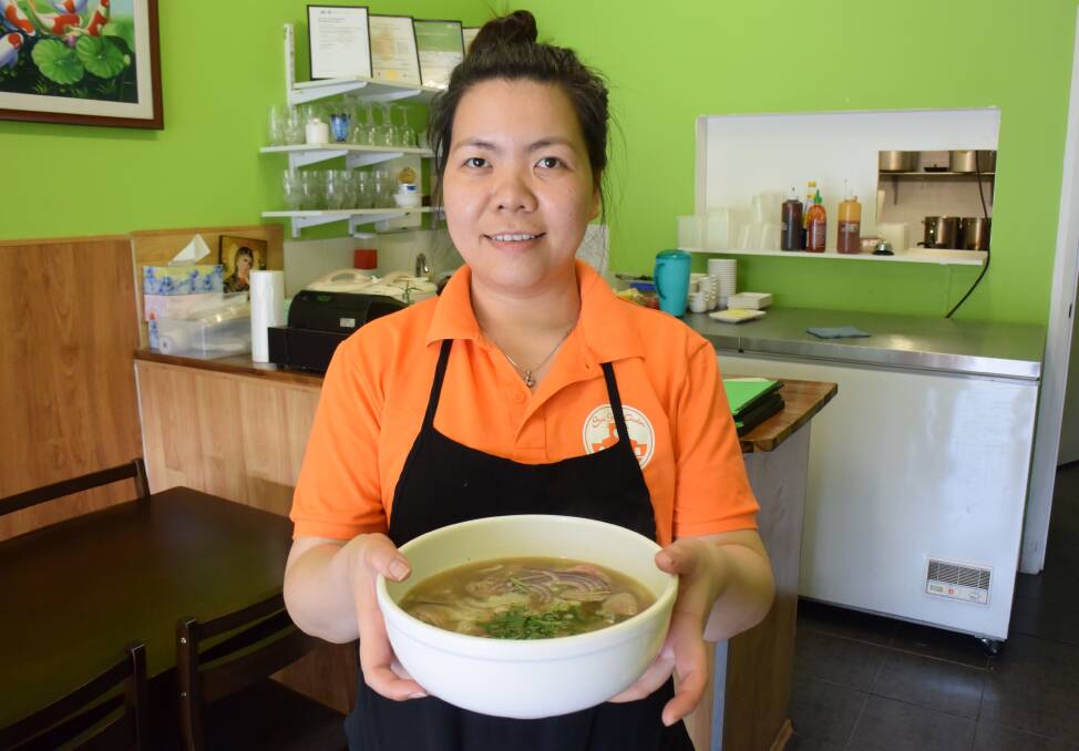 TASTY PHO: Sai Gon Quan's Pheobe Nguyen with the restaurant's speciality dish - pho - or noodle soup.