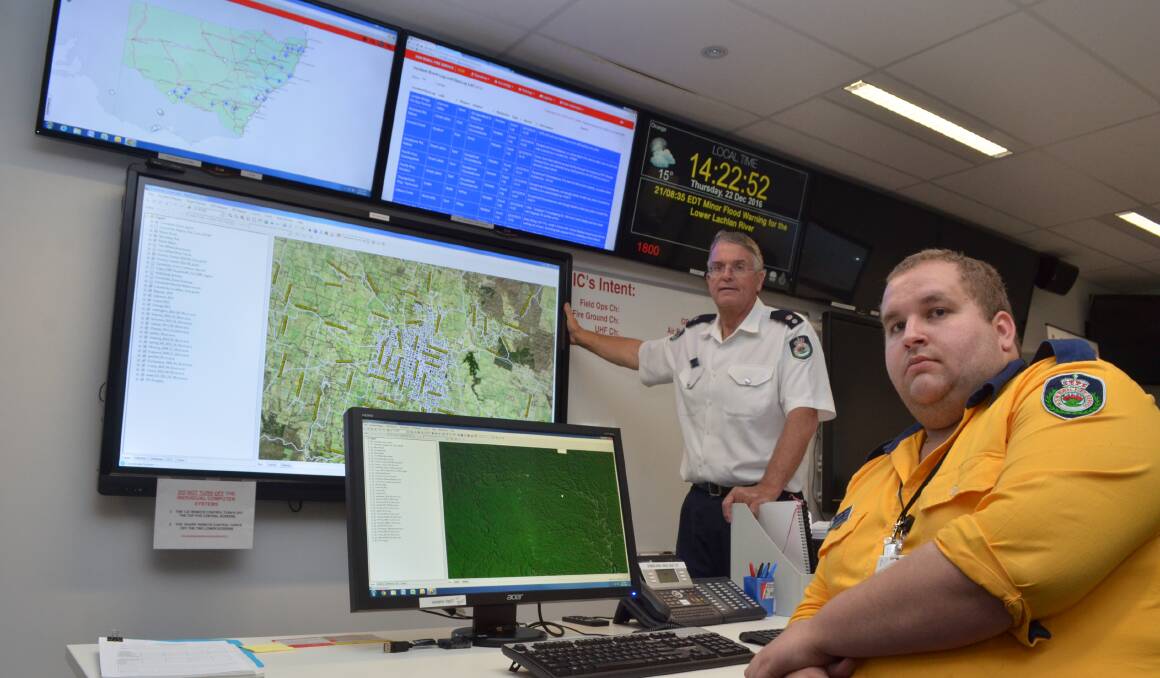 KEEP AN EYE OUT: Superintendent David Hoadley and district officer Lachlan Allan keep a watchful eye on the Canobolas Zone at the Fire Control Centre. Photo: DECLAN RURENGA 1222drfcc1