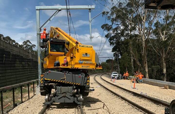 REPAIR WORK: Workers on site to repair damage caused by a significant landslide during heavy rain in early February. Photo: SYDNEY TRAINS