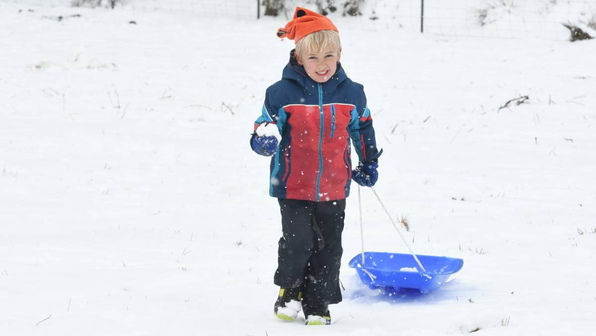 ALL SMILES: Leon Smedley was among thousands of residents who embraced the weekend's winter wonderland. Photo: JUDE KEOGH